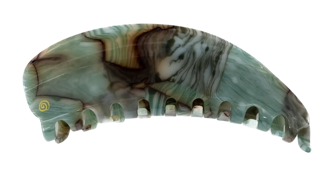 A single curved hair claw clip made from polished agate or jasper stone, featuring a marbled pattern of green, gray, brown, and white with a small yellow spiral detail near the top, isolated on a white background.